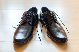 pair of men`s black leather derby shoes